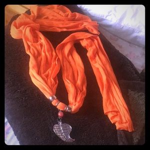 Orange scarf with leaf pendant